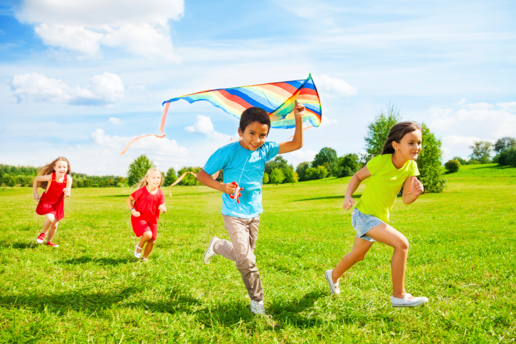 kids running with a kite