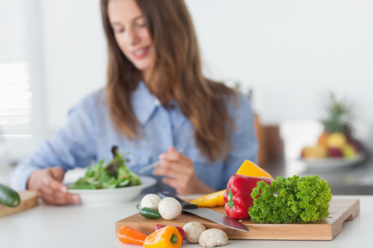 Pretty woman eating a vegetarian salad