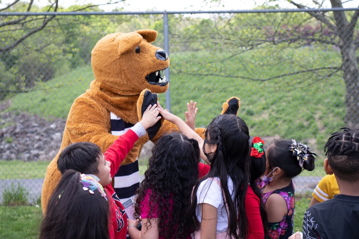 The Nittany Lion cheers on children from Hancock Elementary as they complete their outdoor activities at the Move It Outside event on May 5.